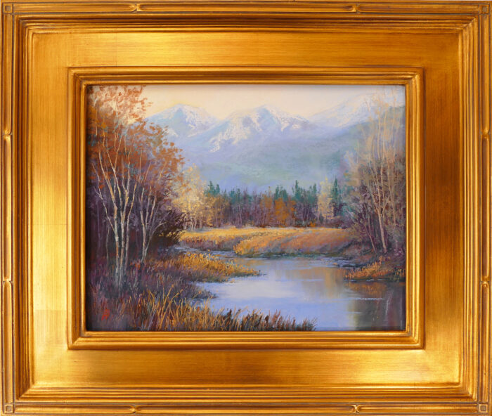 Pastel painting of the north shore of Flathead Lake with the autumn golds and oranges framed in a gold leaf frame.