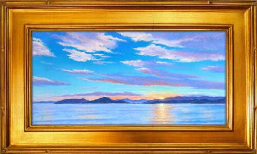 Photo of a painting of a Flathead Lake sunset with frame.