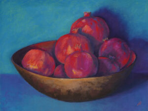 Photo of a pastel painting of a bowl of ruby toned pomegranates.