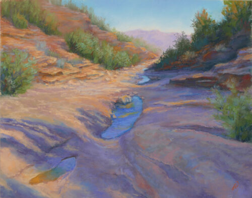 Photo of a pastel painting of a desert wash landscape.