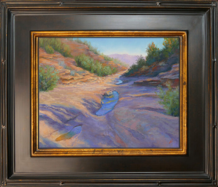 Photo of a pastel painting of a desert wash landscape.