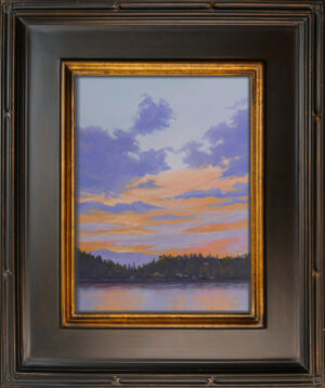 Photo of a framed pastel painting of a sunset over Woods Bay in Bigfork, Montana.