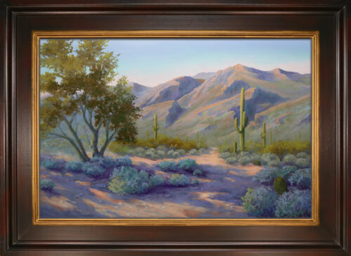A pastel painting of the desert landscape of Sabino Canyon in Tucson with brown wood and gold inset frame.