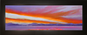 A pastel painting of a colorful sunset over Flathead Lake with black wood frame.