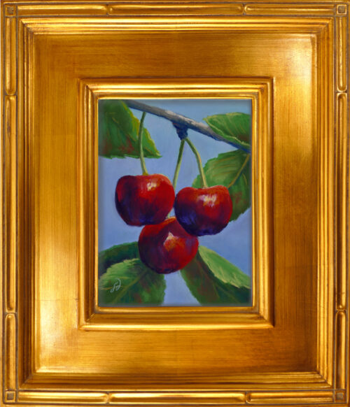 Photo of a pastel painting of a trio of cherries with frame.
