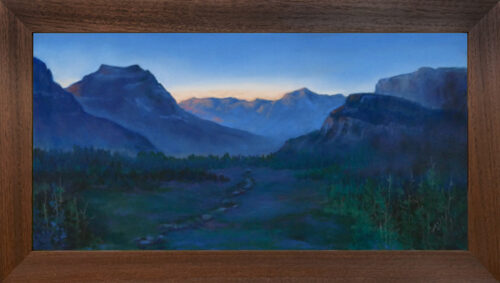 Photo of a pastel painting of the sun rising over Logan Pass in Glacier National Park with brown frame.