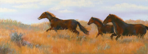Photo of a pastel painting of horses running.