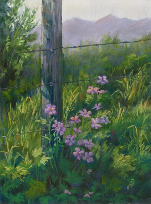 Photo of a pastel painting of flowers next to a fence post.