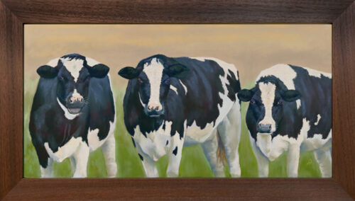 Photo of a pastel painting of three Holstein cows with brown frame.