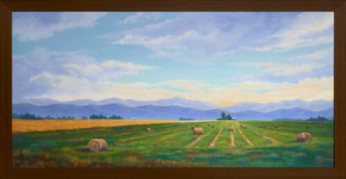 Photo of a pastel painting of farmland with brown frame.